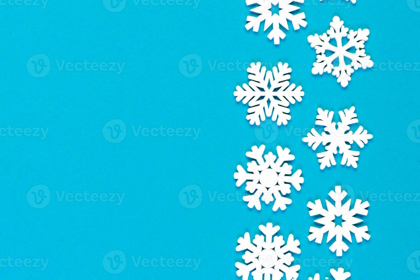 Top view of white snowflakes on colorful background. Winter weather concept with copy space. Merry Christmas concept photo