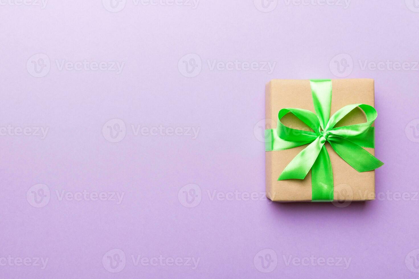 Holiday present box over colored background, top view. Copy space for design photo
