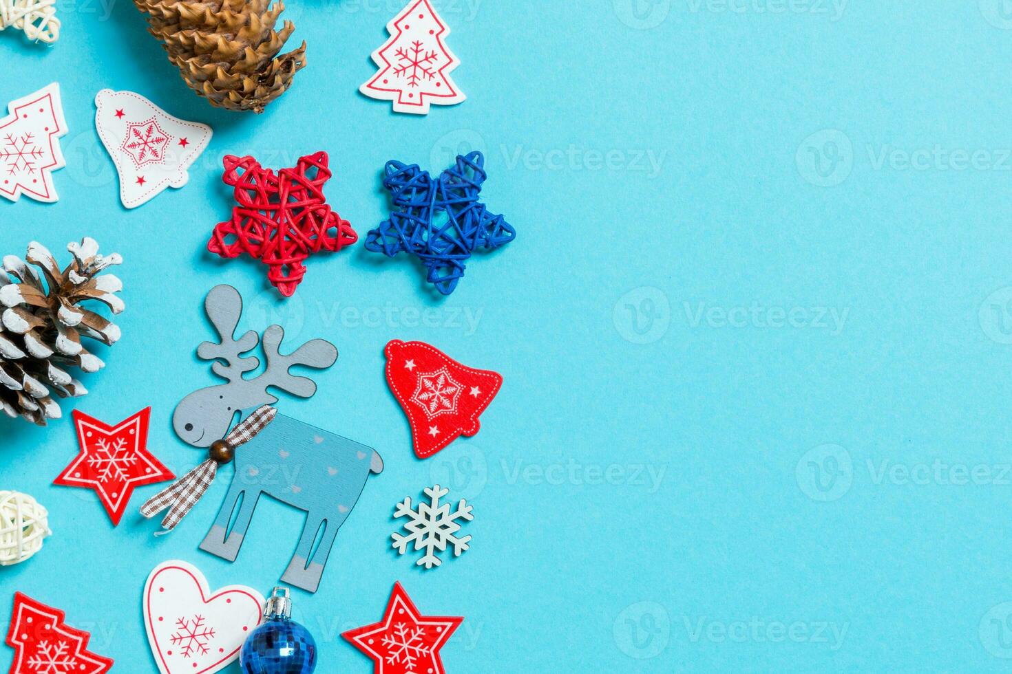 Top view of New Year toys and decorations on blue background. Christmas time concept with empty space for your design photo