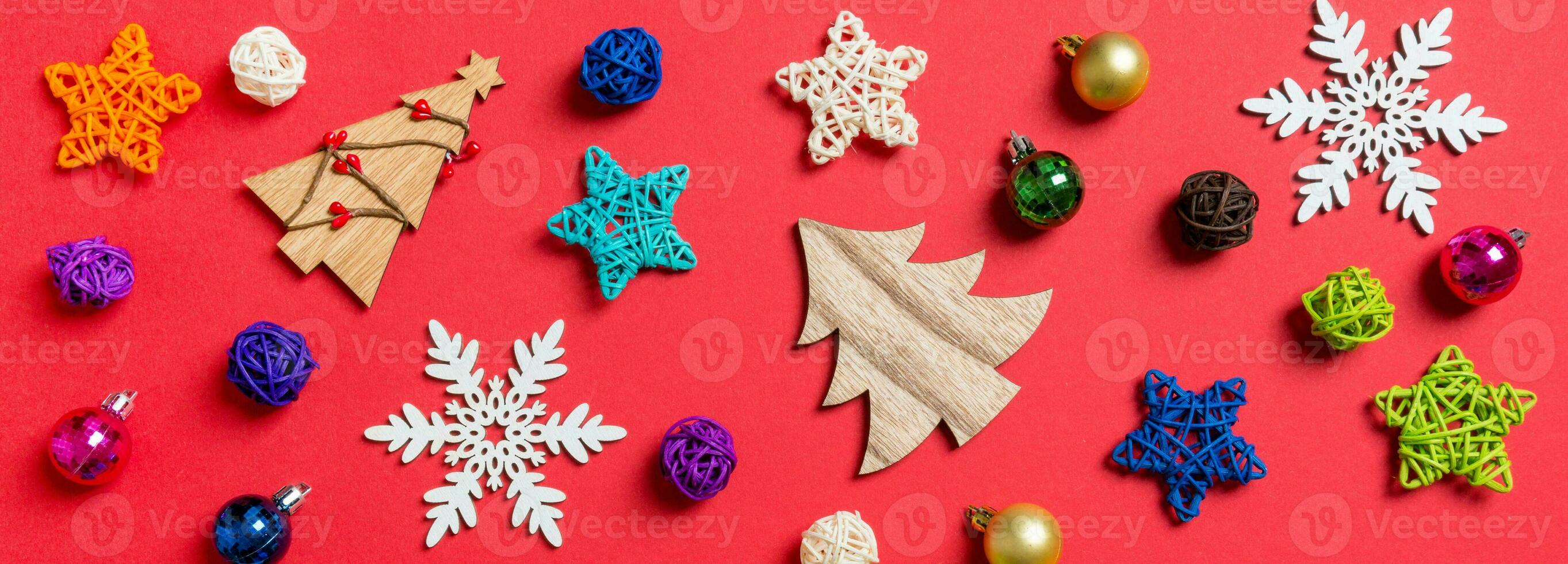 Top view Banner of holiday decorations and toys on red background. Christmas ornament concept photo