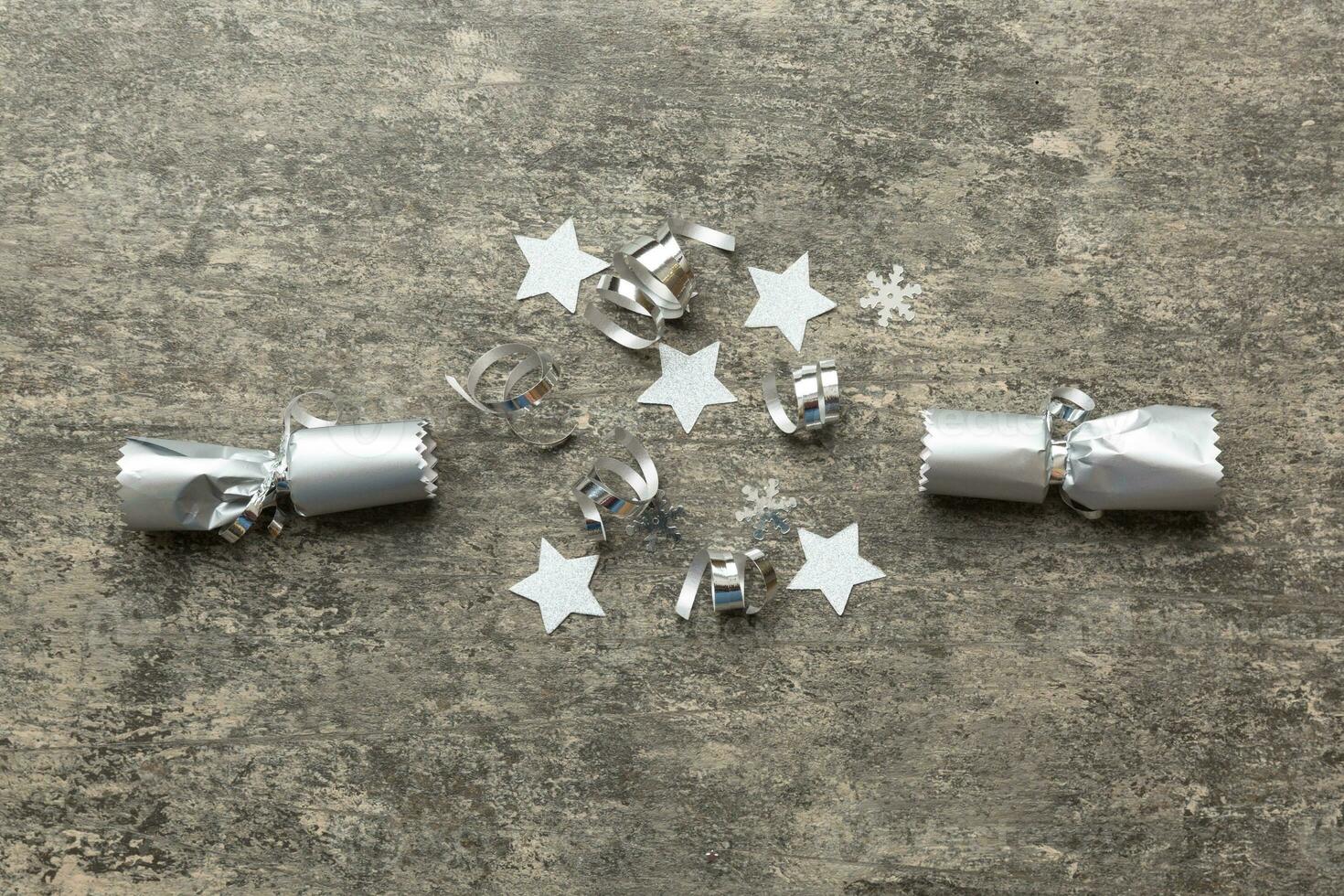 Christmas crackers with shiny confetti on color background, top view, copy space photo