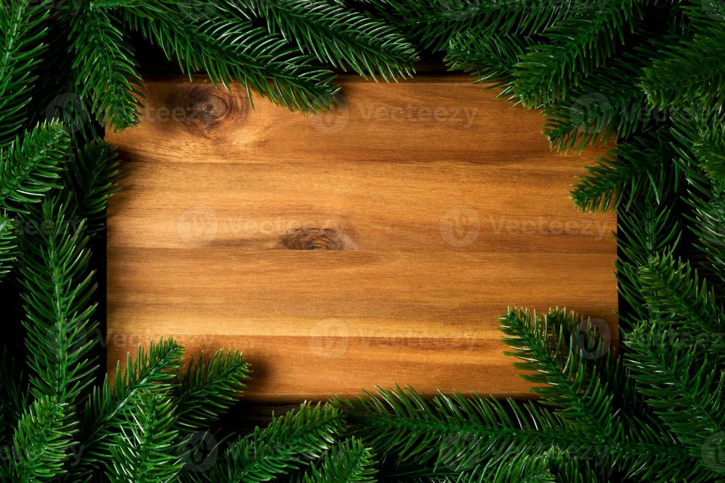 Top view of wooden plate decorated with fir tree branches. New Year dinner concept with empty space for your design photo