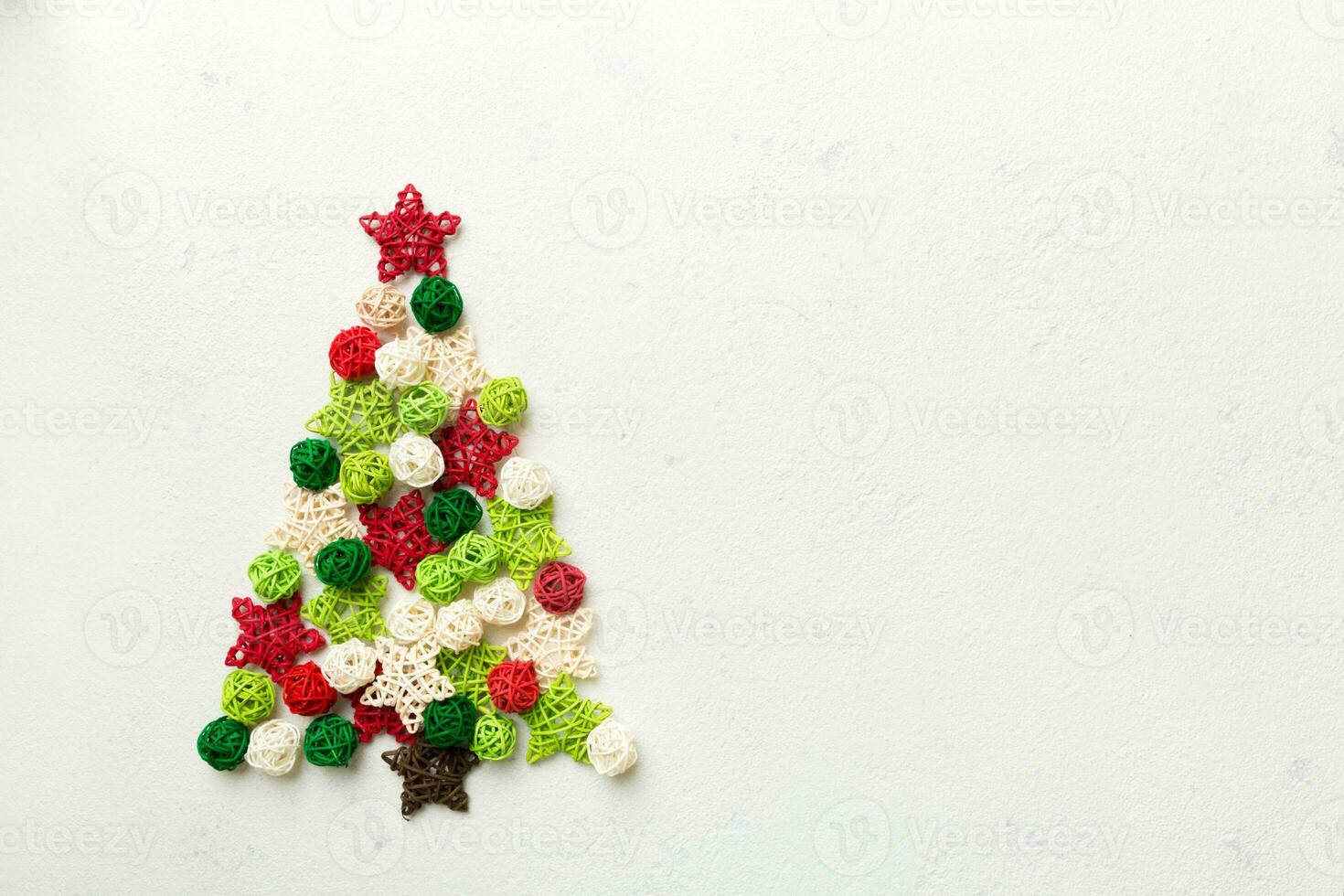 Christmas tree made from colored handmade ball decoration on colored background, view from above. New Year minimal concept with copy space photo