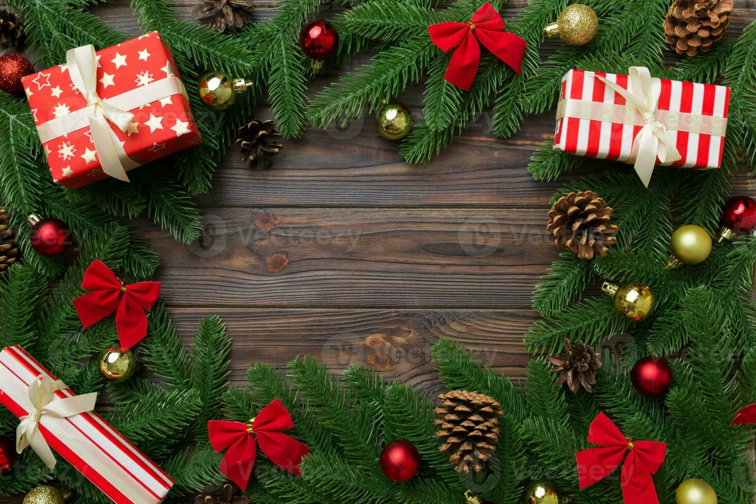 Christmas decorations and fir tree branch and gift boxon dark table. Top view frame with copy space photo