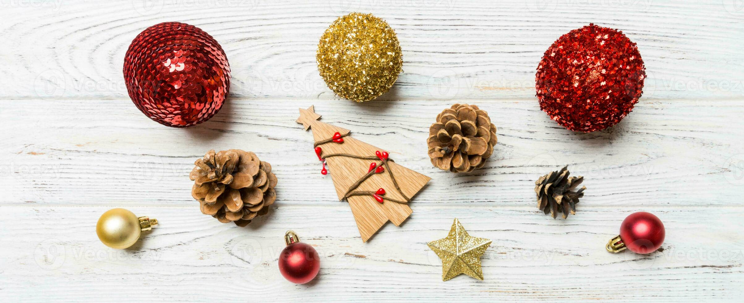 Winter set made of Christmas balls and various decorations on holiday wooden background. Top view of New Year concept with copy space photo
