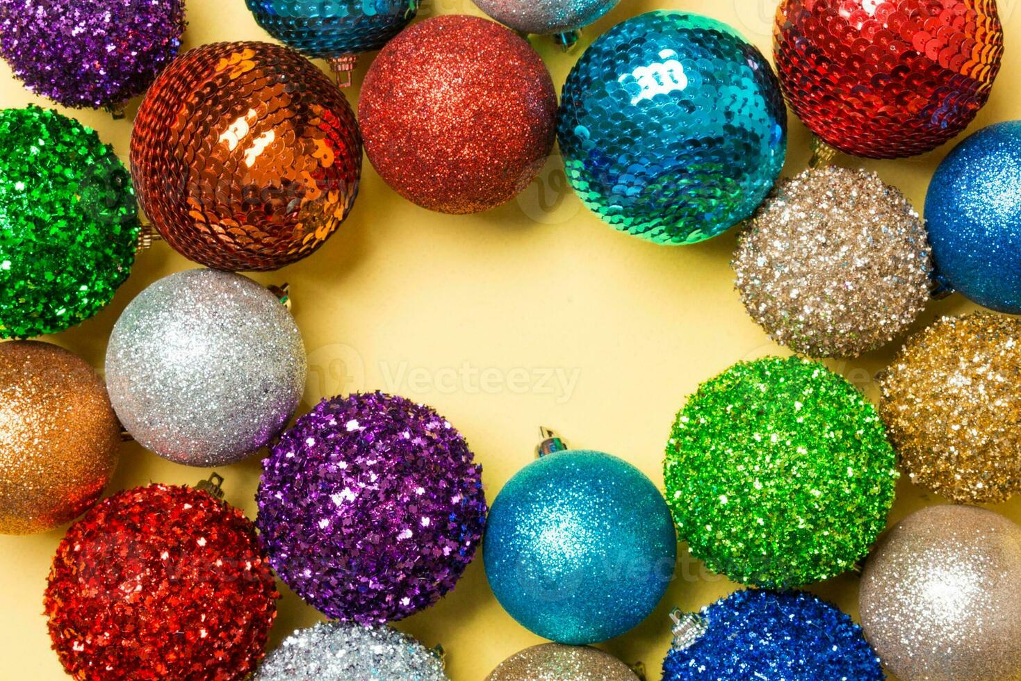 Festive composition of decorative baubles on colorful background. Top view of Christmas toys with copy space photo