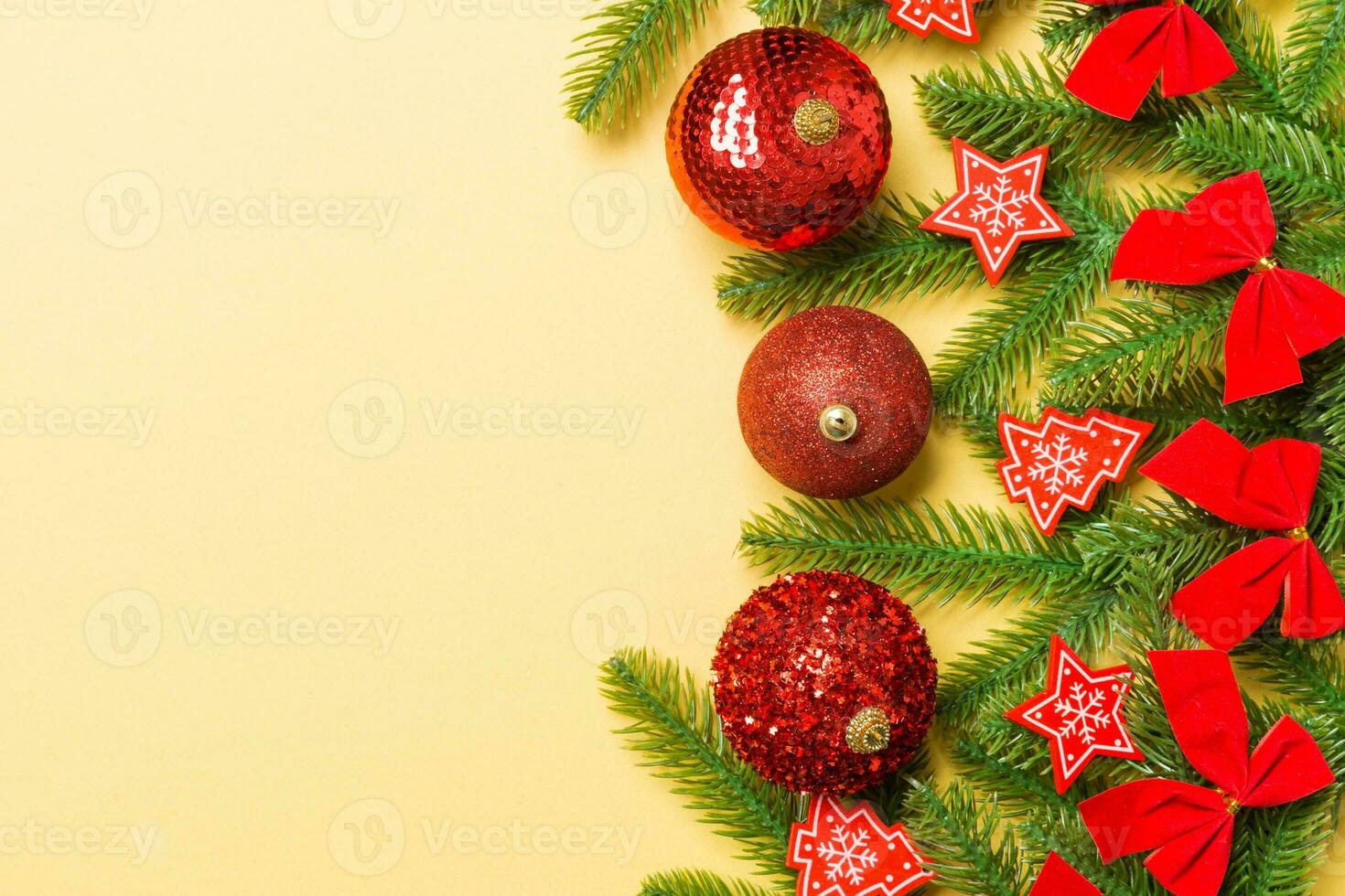 Set of festive balls, fir tree and Christmas decorations on colorful background. Top view of New Year ornament concept with copy space photo