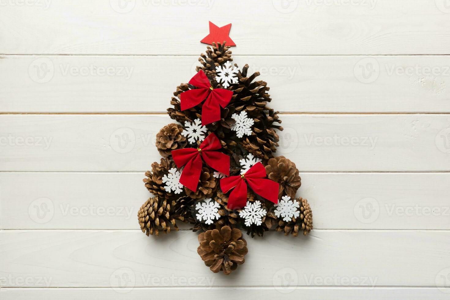 Christmas tree made from natural cones on colored background, view from above. New Year minimal concept with copy space photo