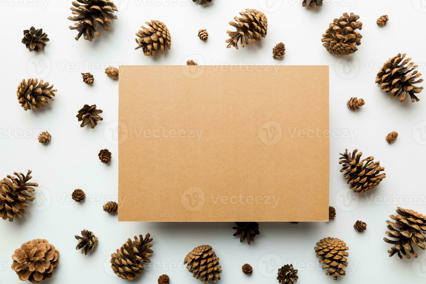 Creative frame made of Christmas pine cones with square Paper blank. Xmas and New Year theme. Flat lay, top view copy space photo