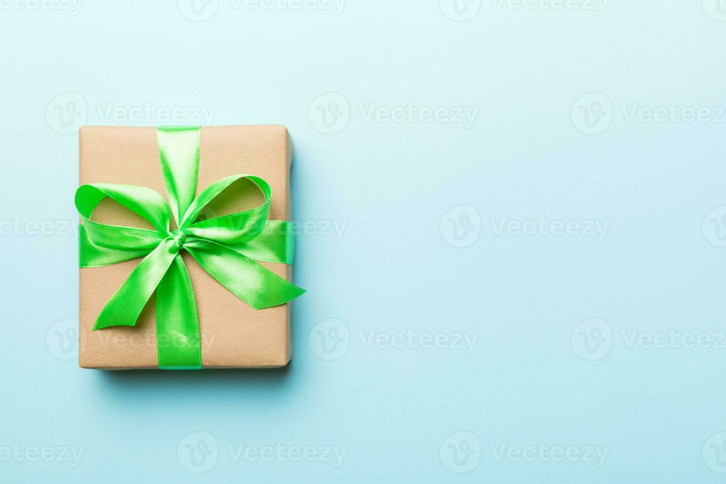 Holiday present box over colored background, top view. Copy space for design photo