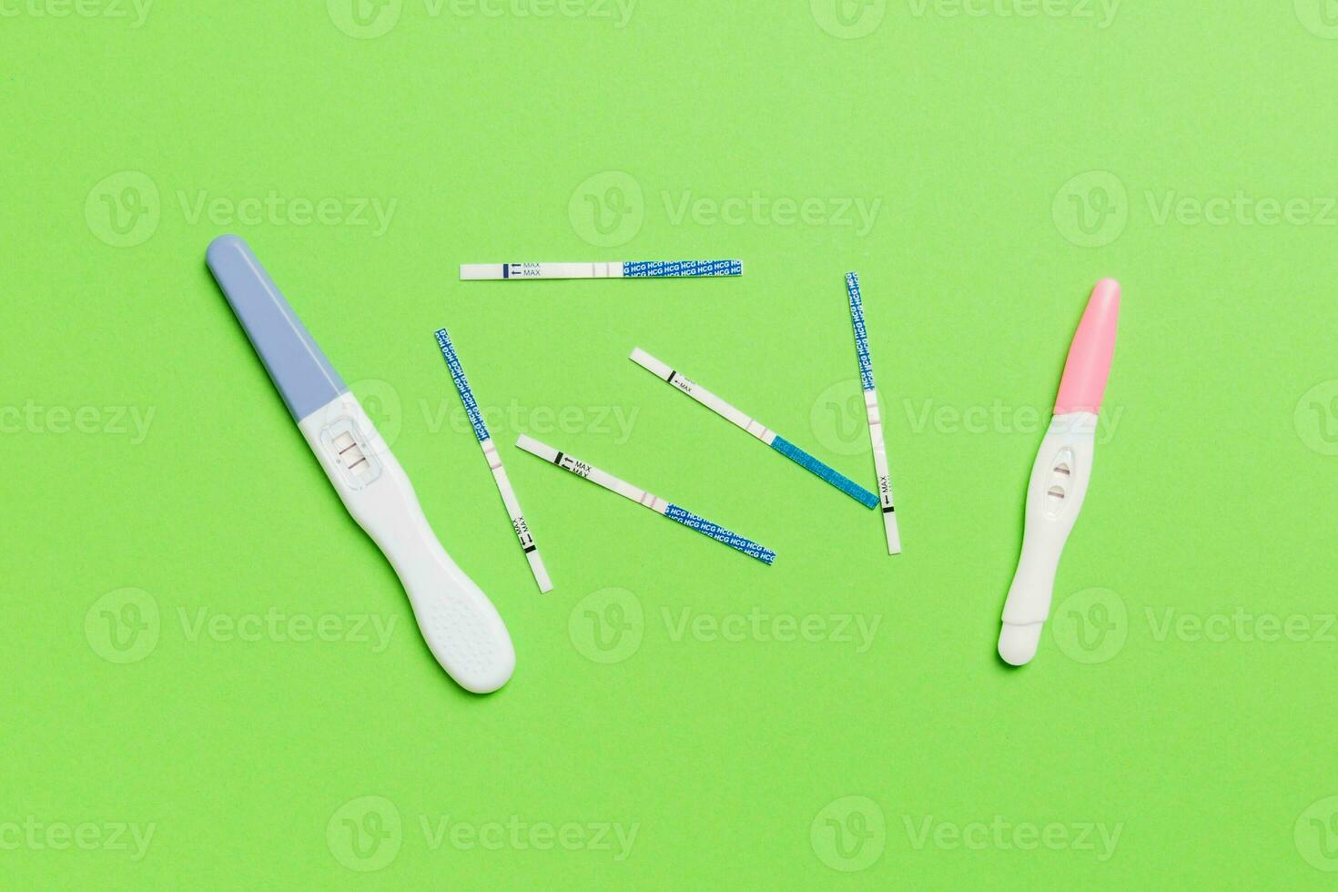 Colored Pregnancy test on colored background, top view with copy space photo