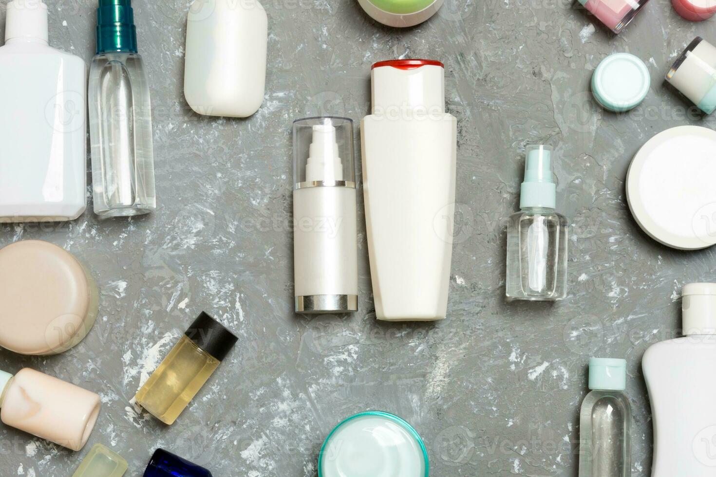 Group of plastic bodycare bottle Flat lay composition with cosmetic products on blue background empty space for you design. Set of White Cosmetic containers, top view with copy space photo