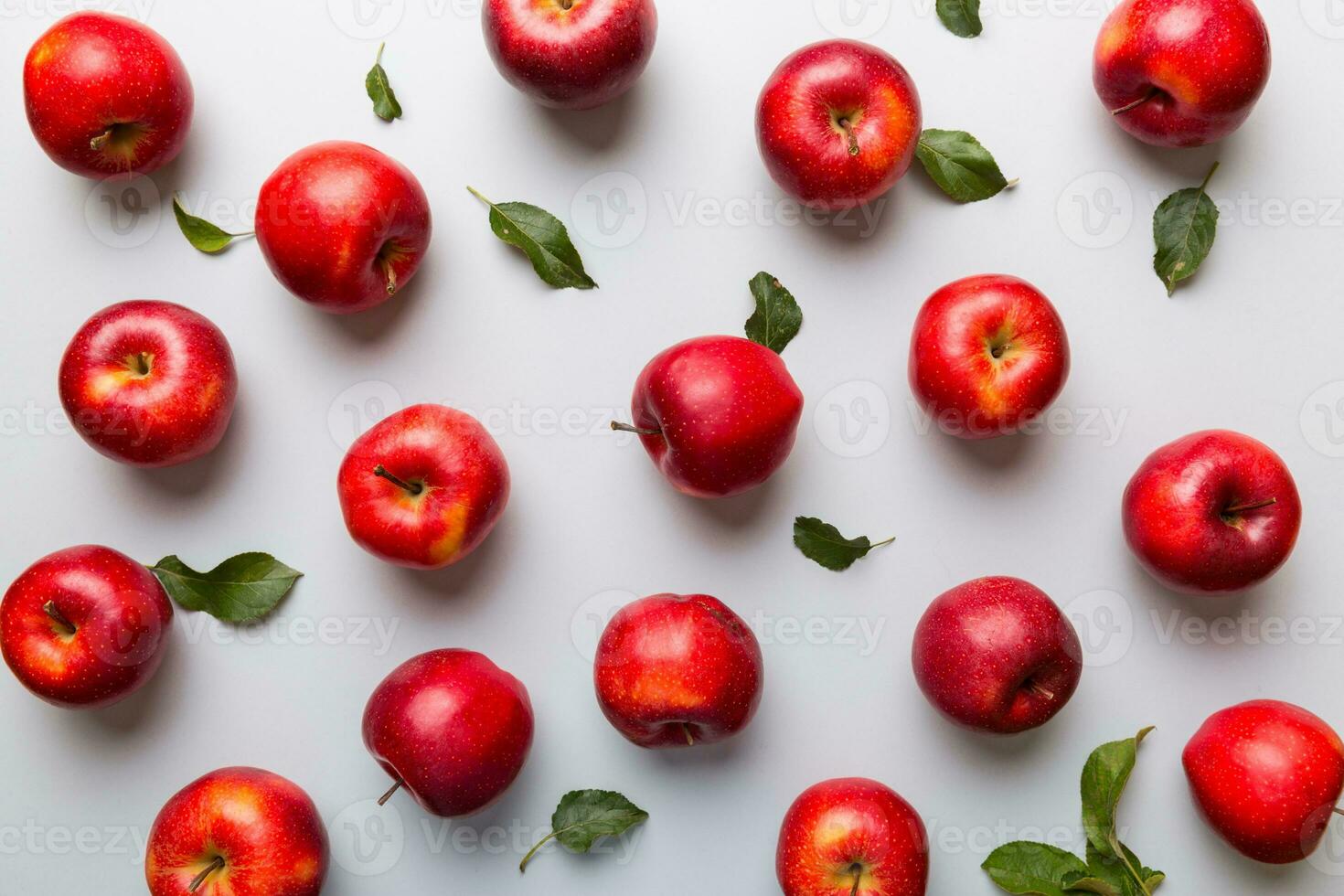 Many red apples on colored background, top view. Autumn pattern with fresh apple above view photo