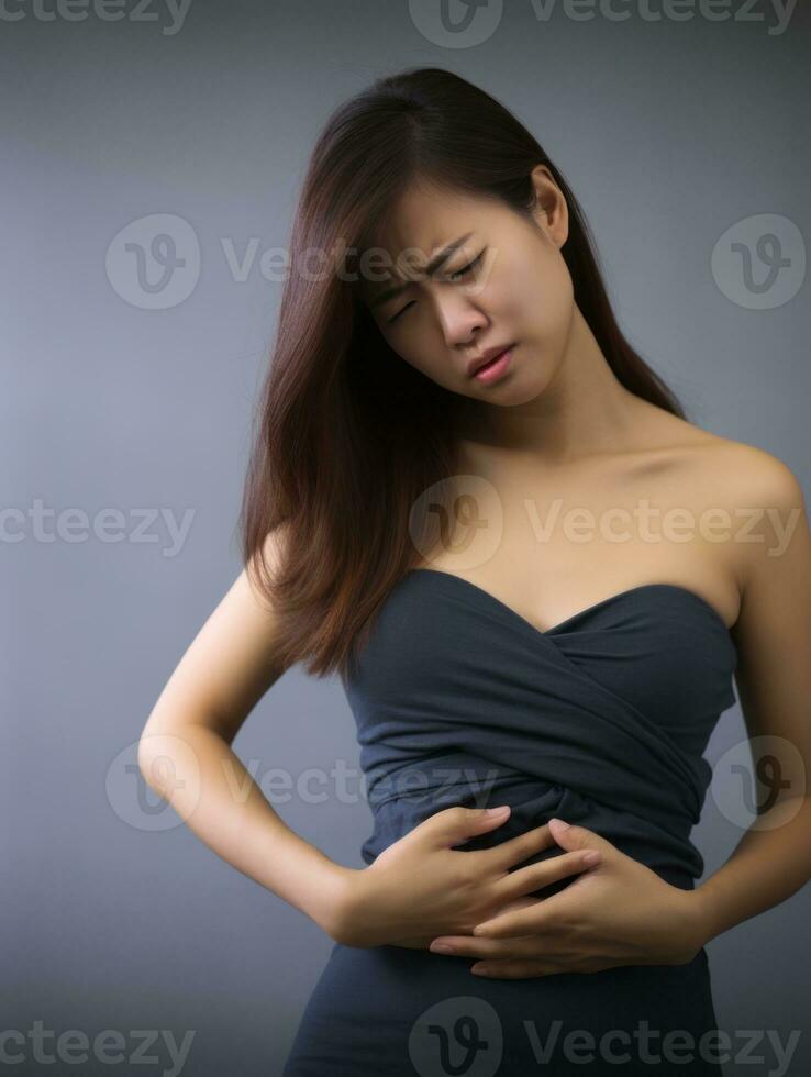 Asian woman appears to be in pain on grey background AI Generative photo