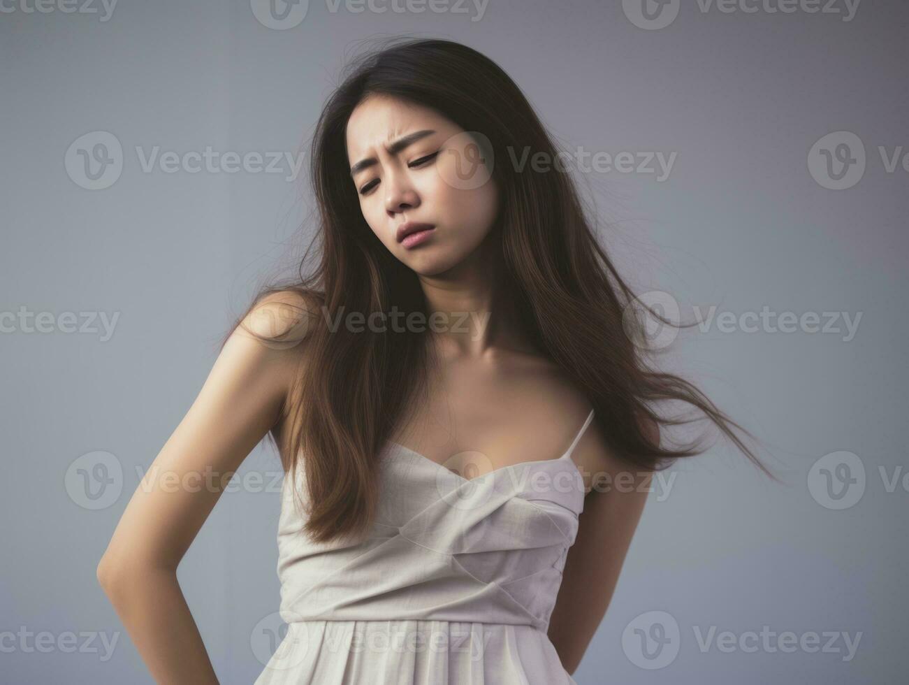 Asian woman appears to be in pain on grey background AI Generative photo