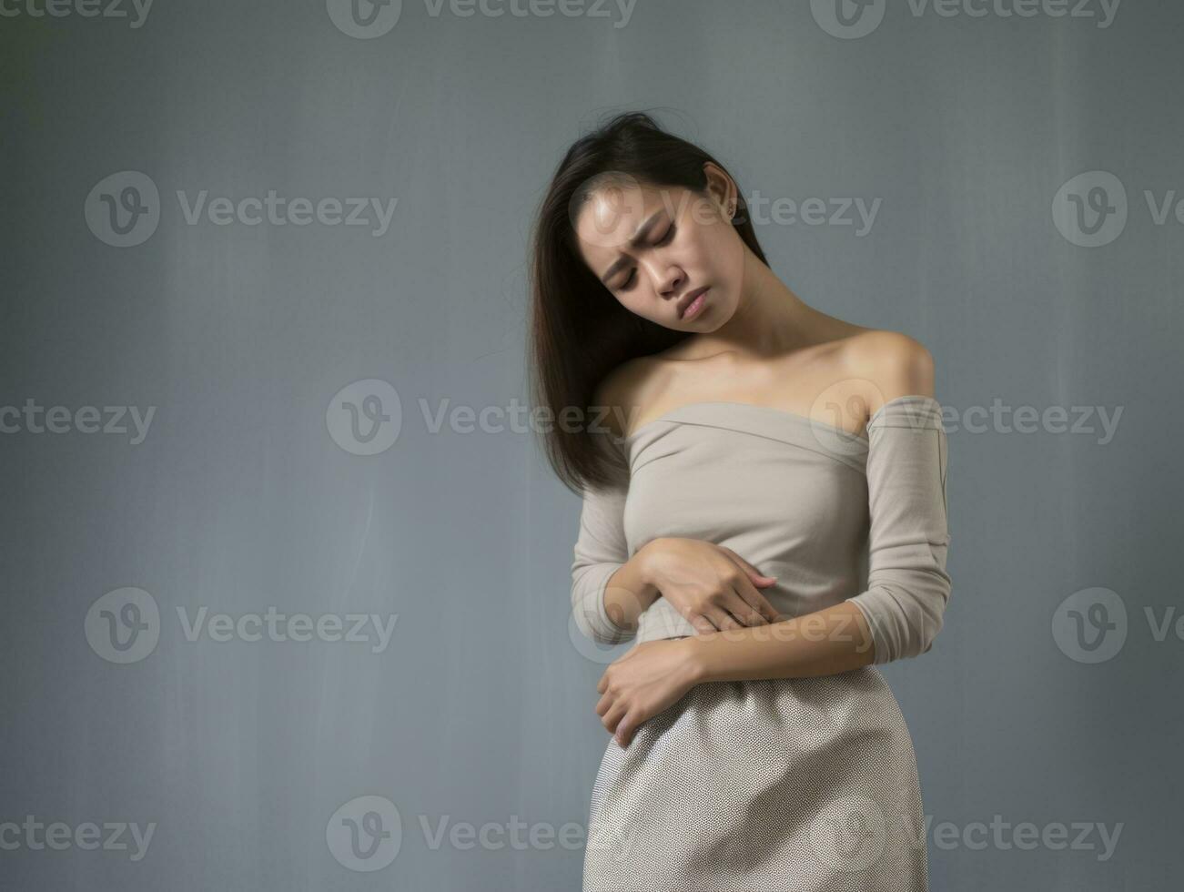 Asian woman appears to be in pain on grey background AI Generative photo