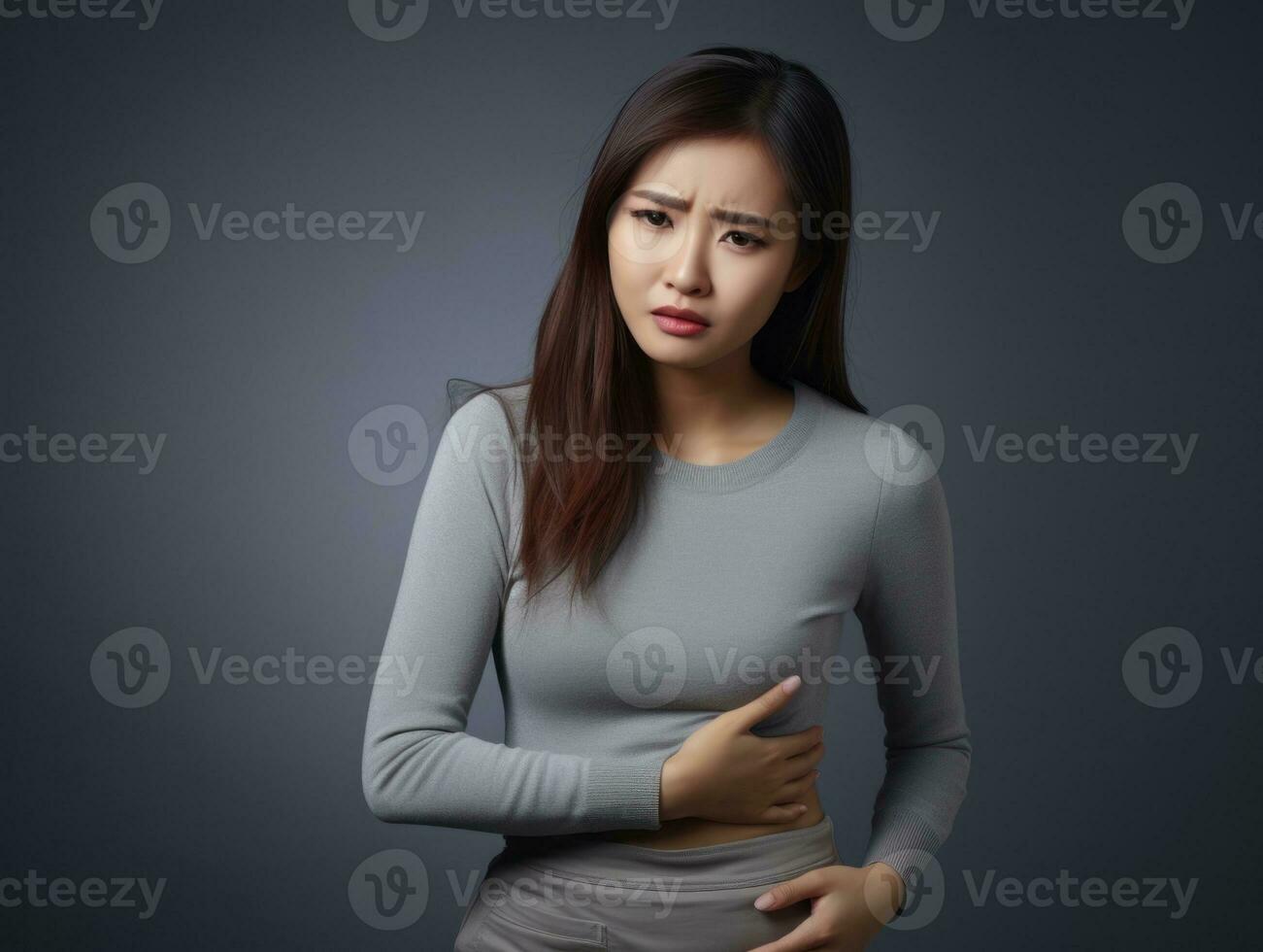 Asian woman appears to be in pain on grey background AI Generative photo