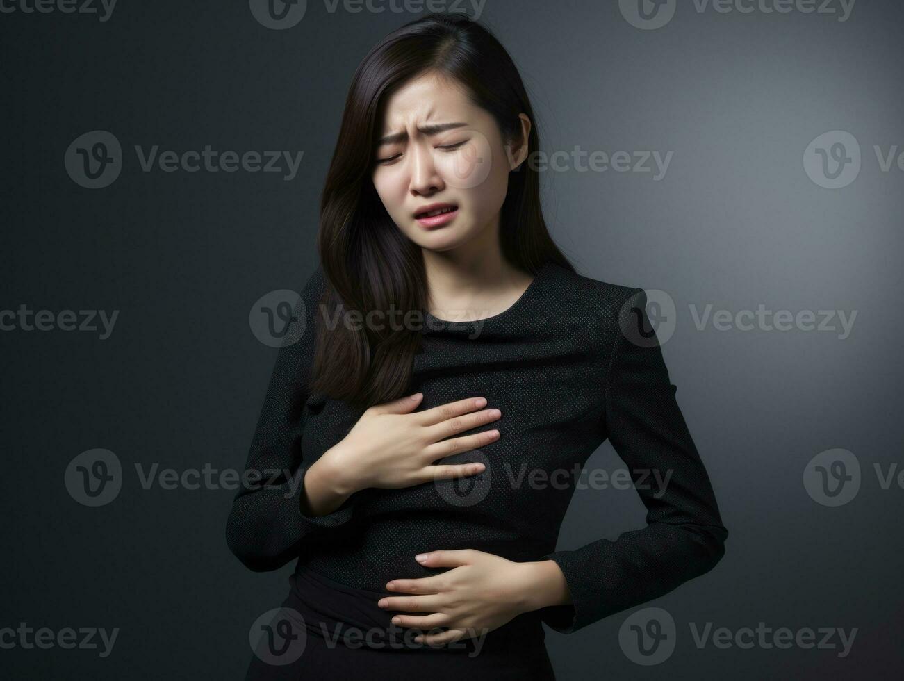 Asian woman appears to be in pain on grey background AI Generative photo