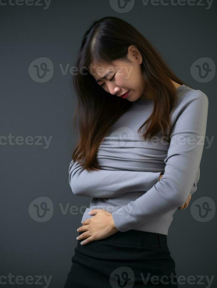 Asian woman appears to be in pain on grey background AI Generative photo