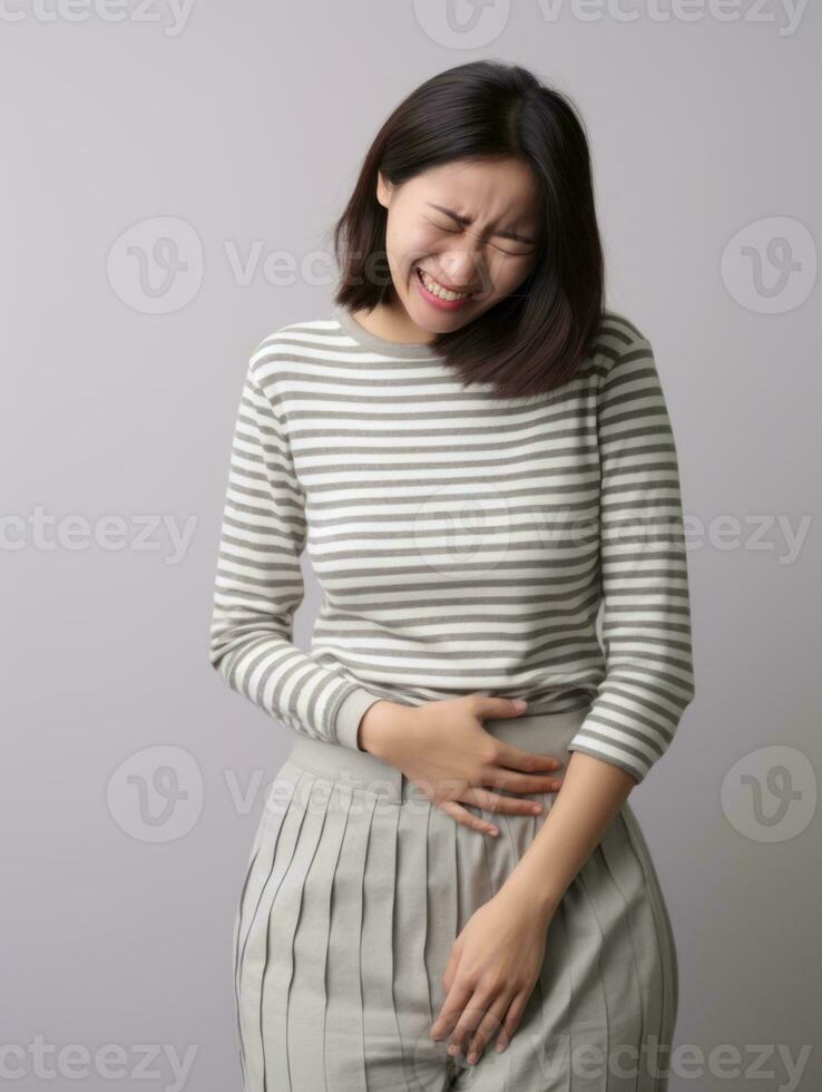 Asian woman appears to be in pain on grey background AI Generative photo