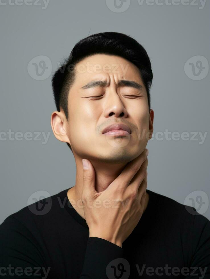 Asian man with pain on neutral background AI Generative photo