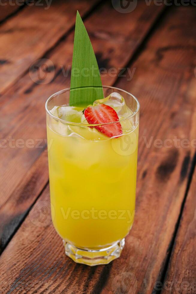 mai tai cocktail with pineapple and rum with a piece of strawberry photo