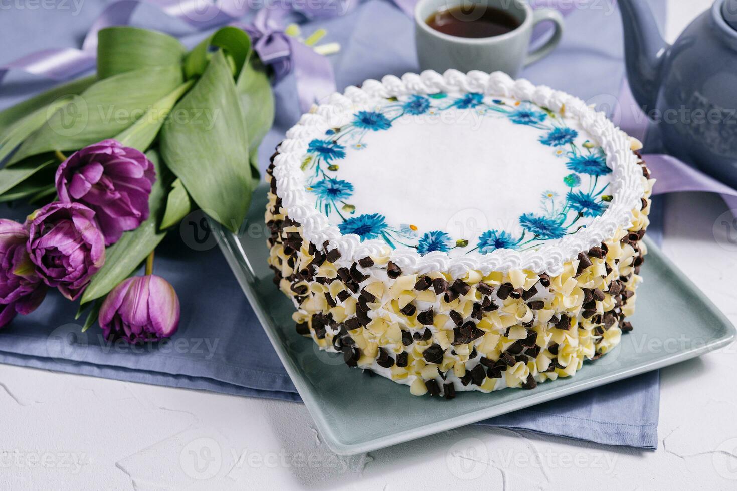 cake with white cream and flowers tulips photo