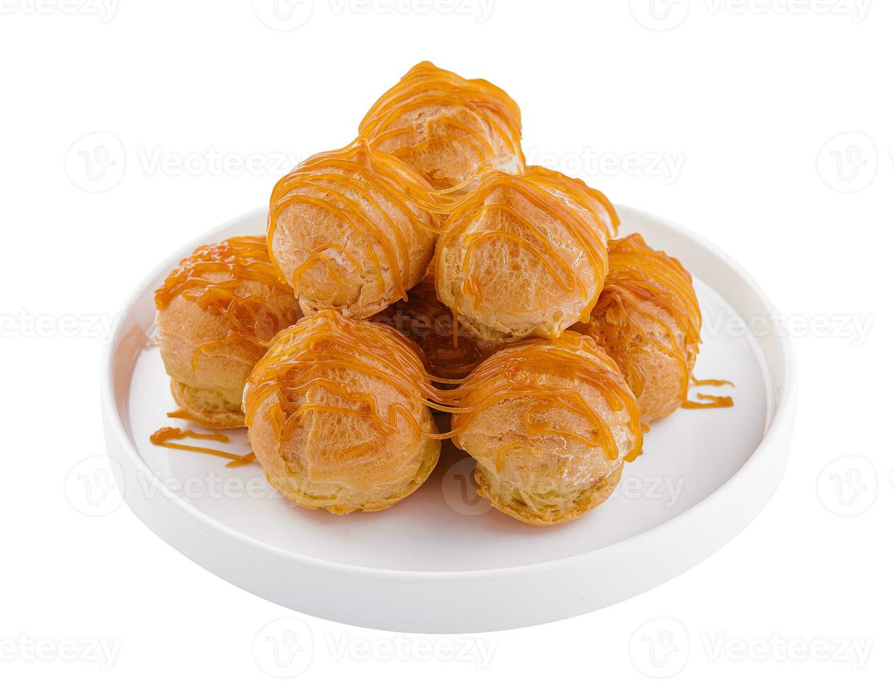 Tasty round eclairs with cream on white background photo