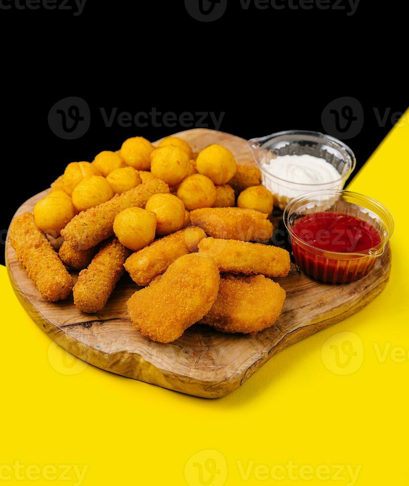 nuggets and cheese balls with sauces photo