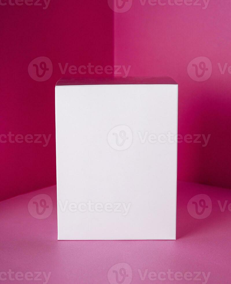White gift box on pink background photo