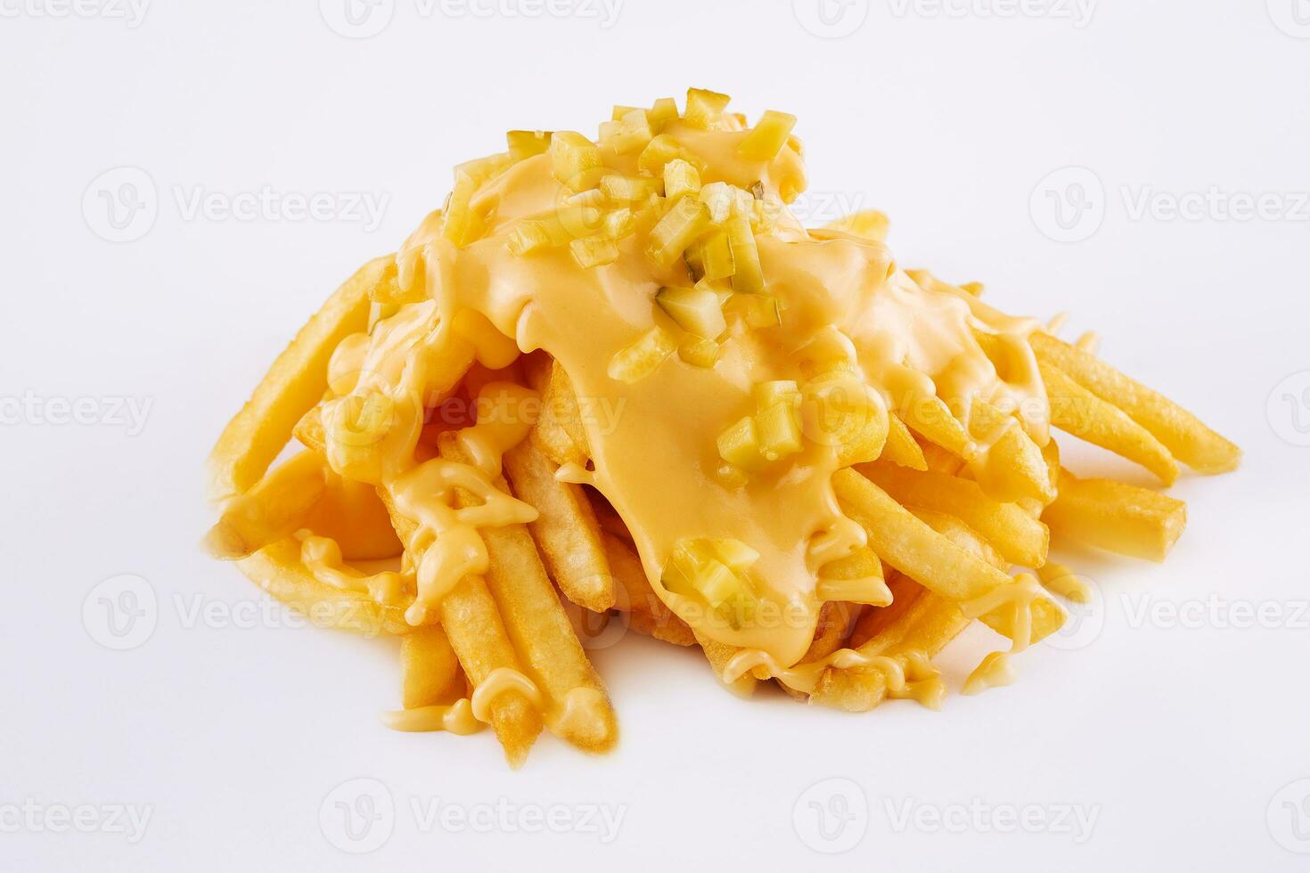 Pouring cheese sauce on french fries on white background photo