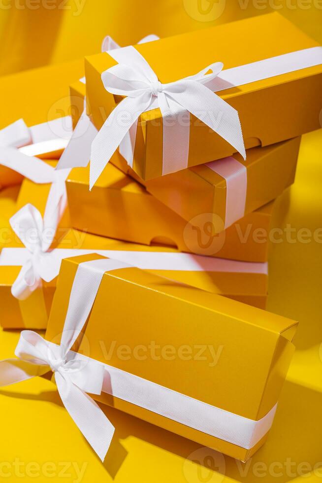 Yellow gifts on a yellow background photo