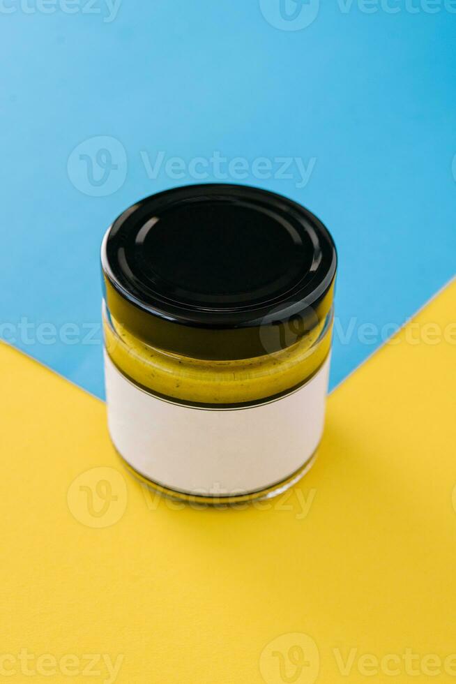 Bottle of curry sauce on blue with yellow background photo