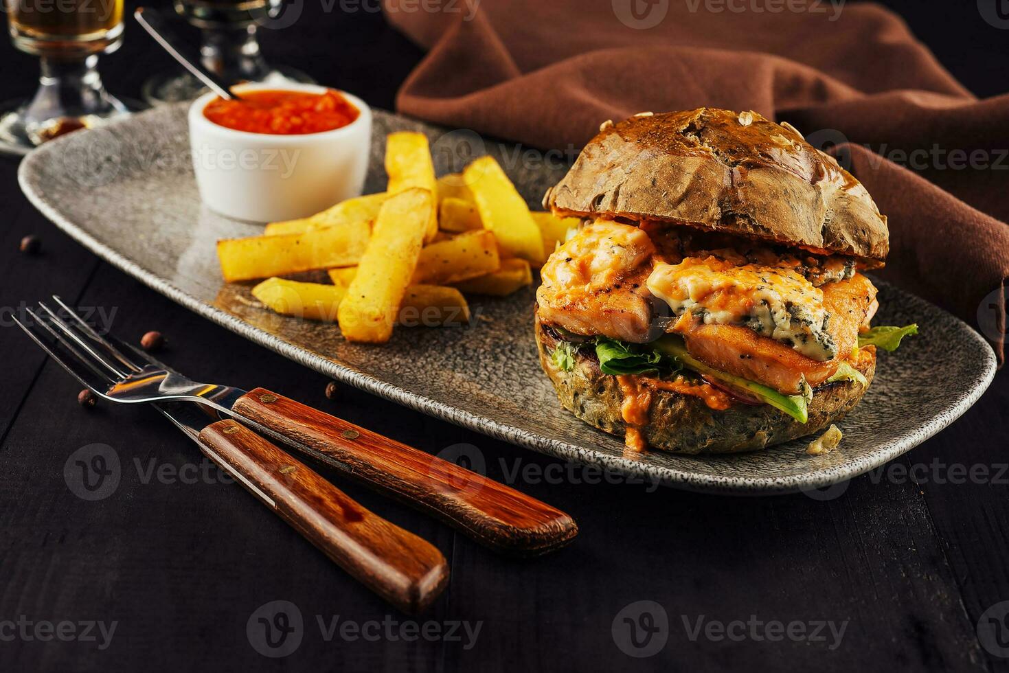 Burger with salmon, lettuce and fried potato photo