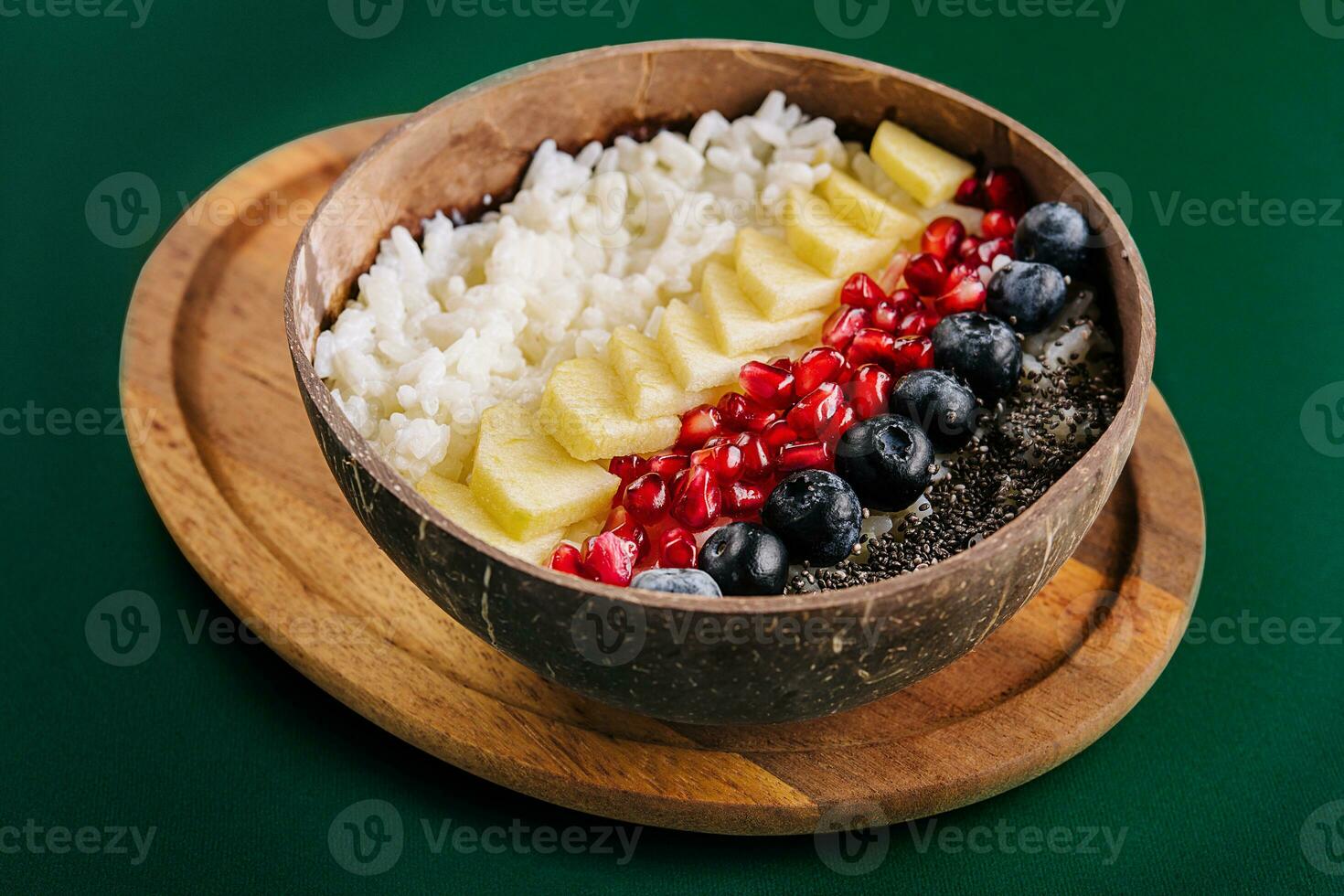 bowl of rice, pineapple, pomegranate and blueberries photo