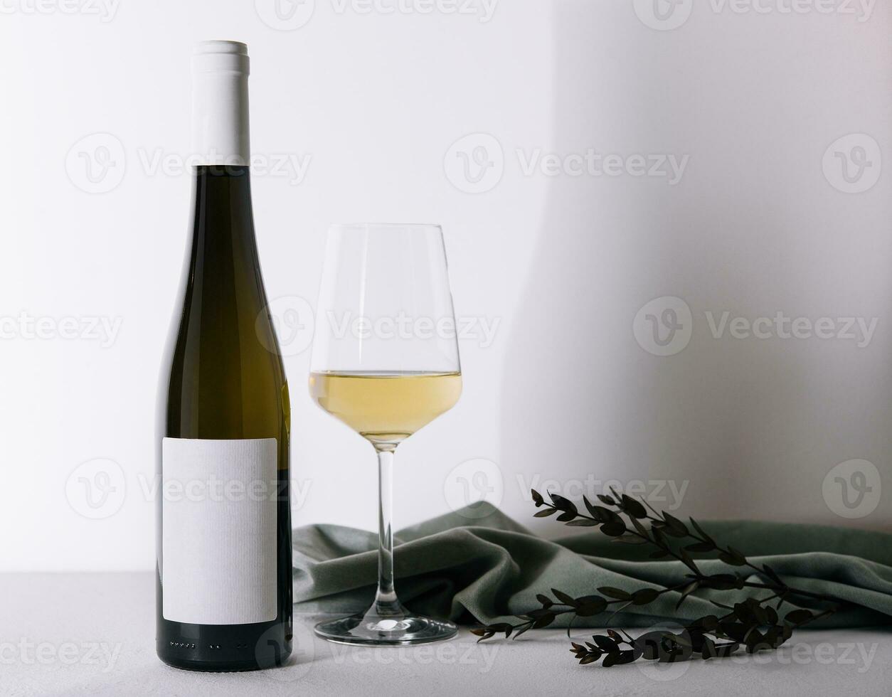 Bottle of wine with a glass of wine photo