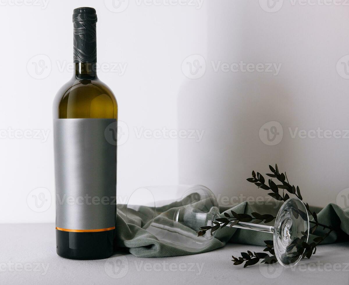 glass and bottle of wine on white photo