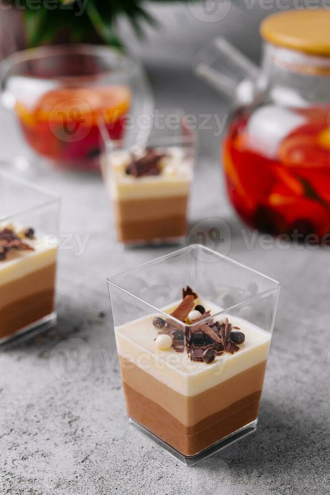 Layered dessert Trifles in a transparent glasses photo