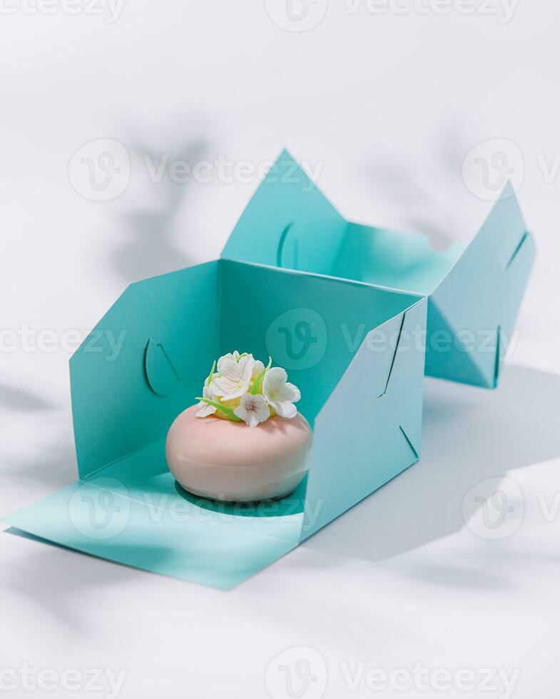 Luxury pink mousse cake in gift box photo