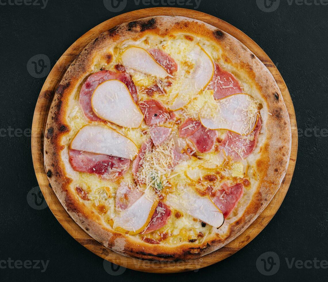 Delicious meat pizza with salami, ham and cheese photo