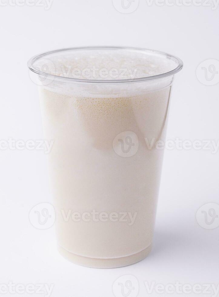 Vanilla milkshake covered with whipped cream in plastic glass photo