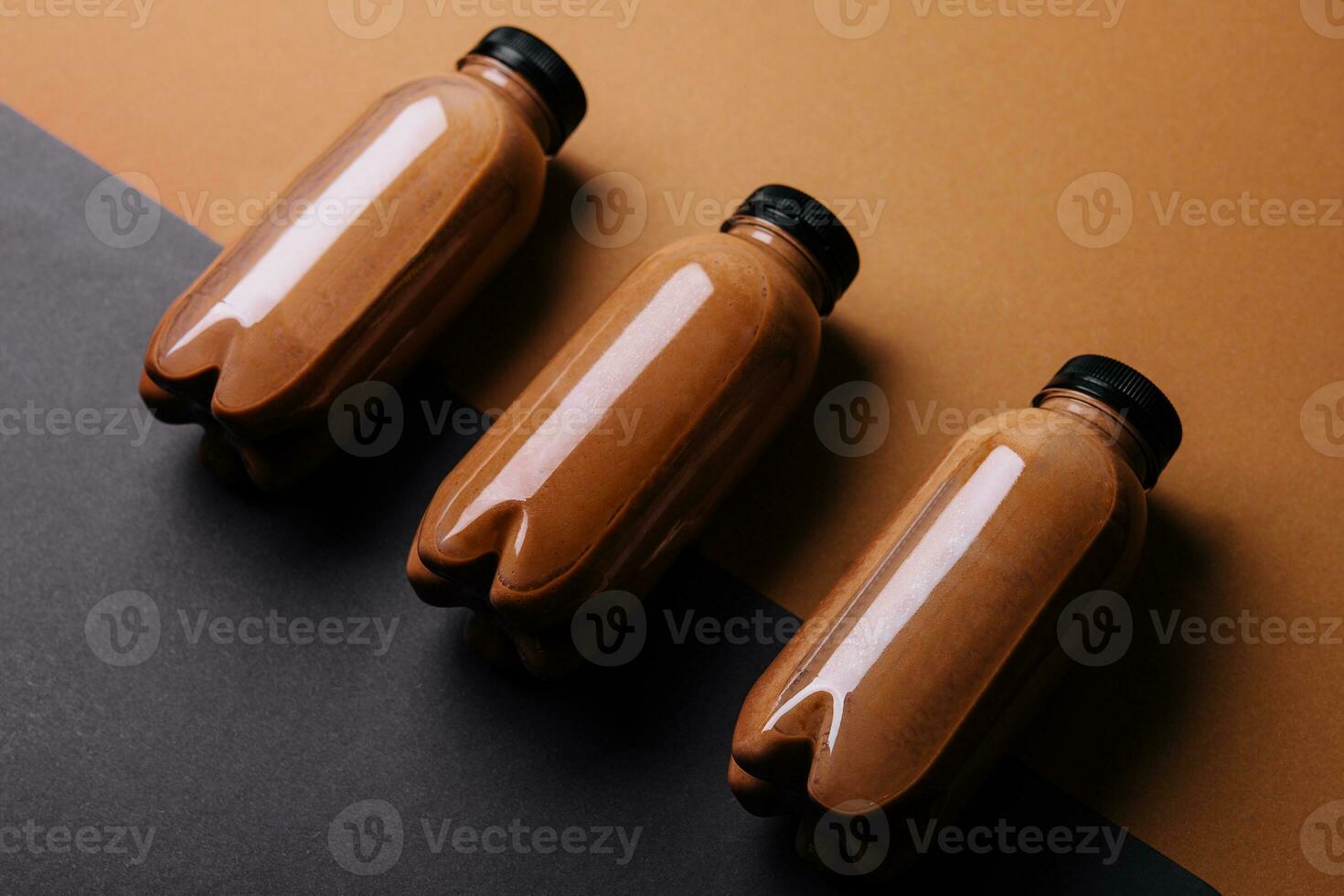 chocolate smoothies milkshake in bottles on brown background photo