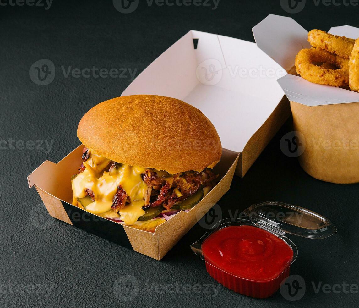 Barbeque Pulled Pork Burger and onion rings photo