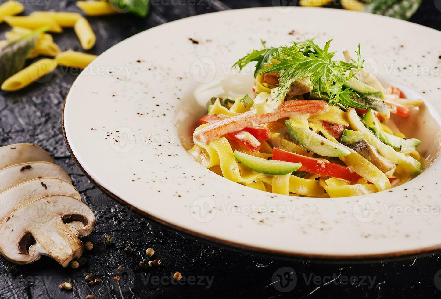 Bolognese pasta with mushrooms, cucumbers and peppers in sauce photo