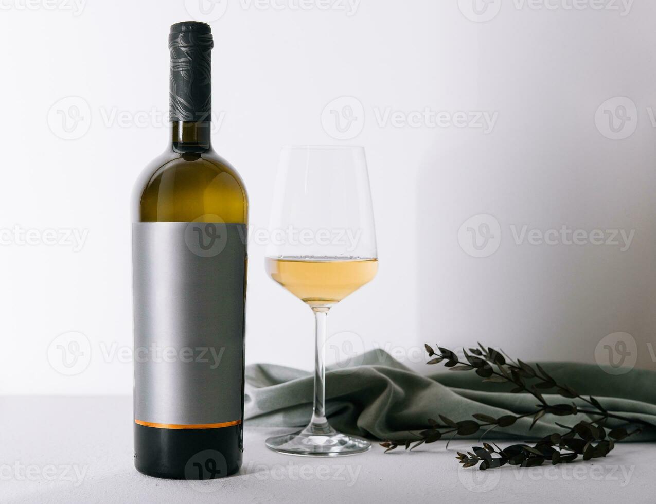 glass and bottle of wine on white photo
