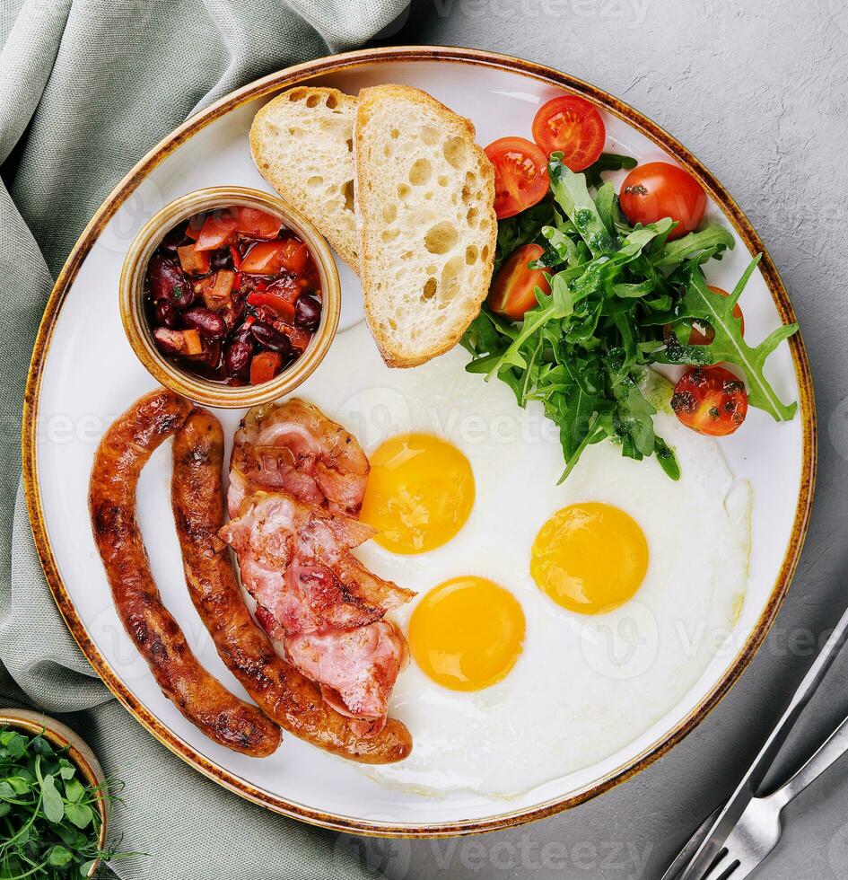 Fried eggs and bacon for breakfast on a plate photo