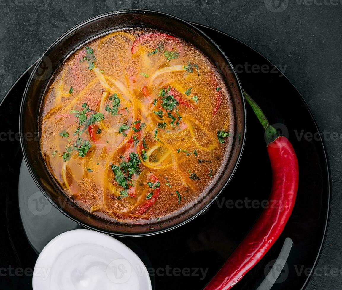 Chicken soup with noodles top view photo