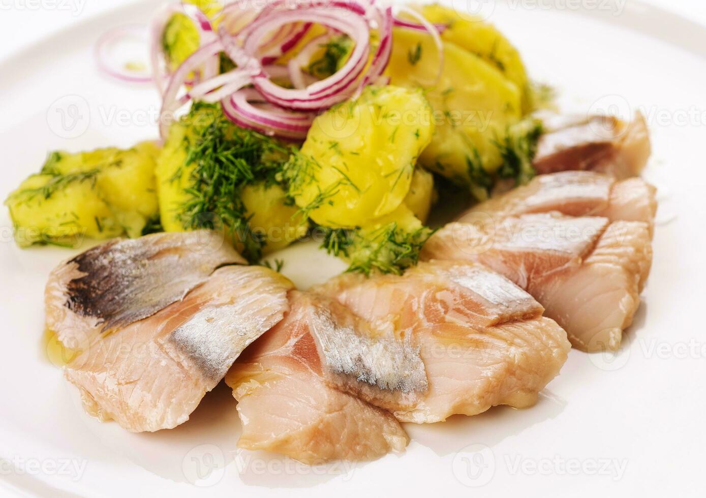 Salted fish with boiled potato and pickled onions photo
