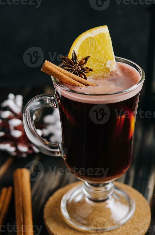 Winter hot drink mulled wine with cinnamon and lemon photo