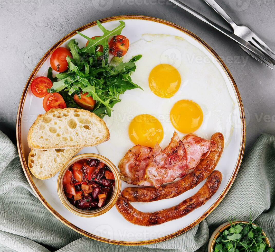 Fried eggs and bacon for breakfast on a plate photo